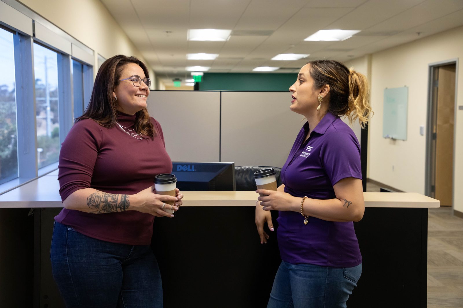 Amber and Kathy talking over coffee