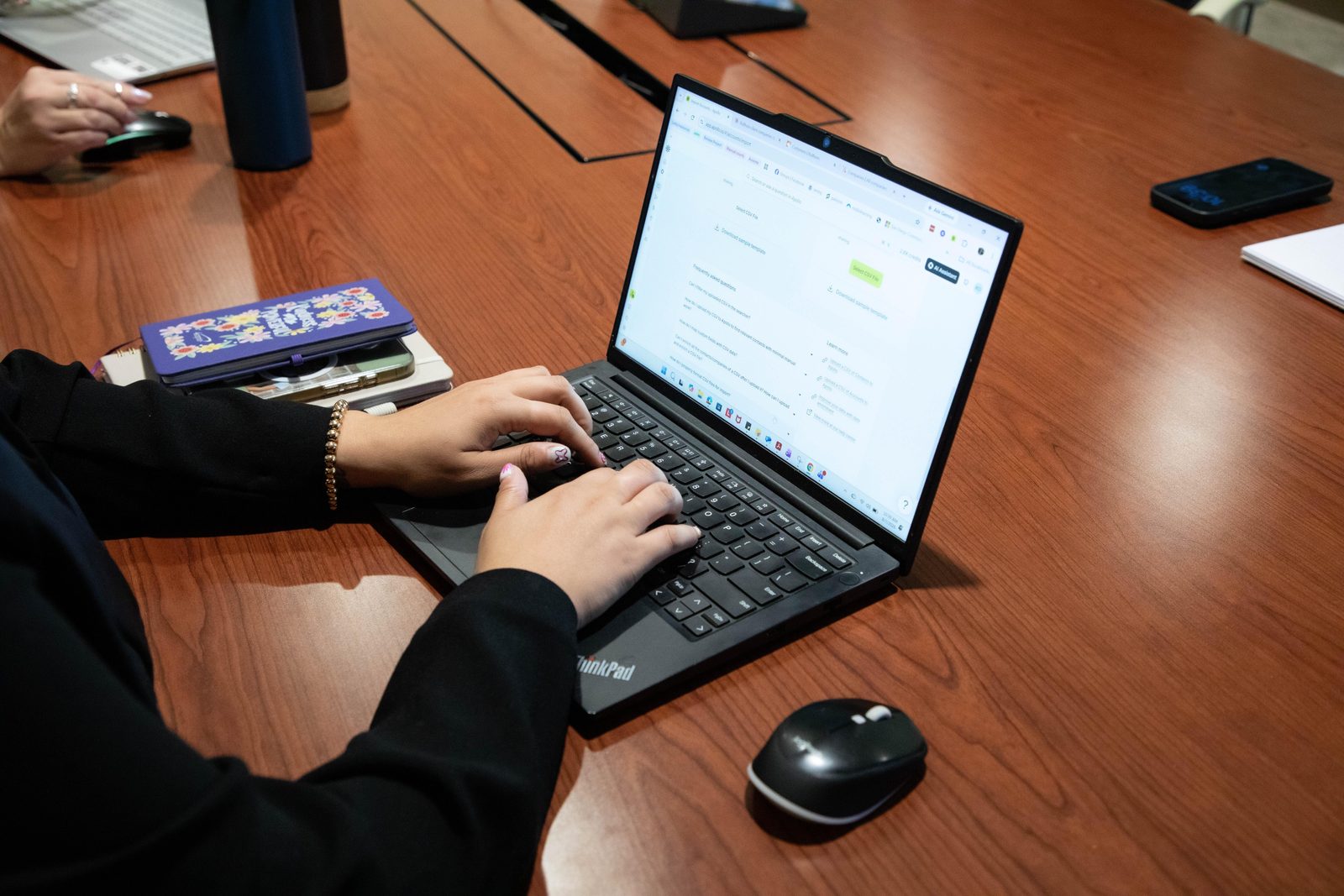 Hands working on a laptop