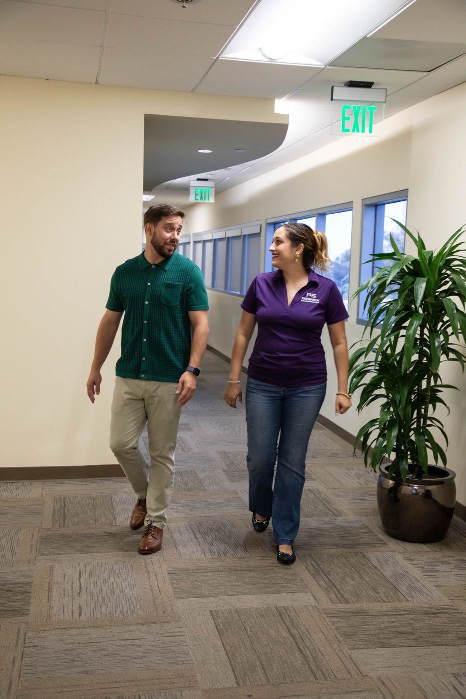 Reid and Kathy walking through the office
